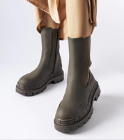 Deep green Dralyn Urban Rubber Boots with zip closure, featuring a minimalist design and sporty appeal for rainy-day style.