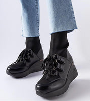Black platform buskin boots with rounded toes, showcasing modern elegance and comfort, set on a sturdy 6 cm heel for added height.