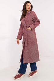 Woman wearing Selvarane Long Double-Breasted Wool Coat with fine stripe pattern and belted waist, styled with casual denim and sneakers.