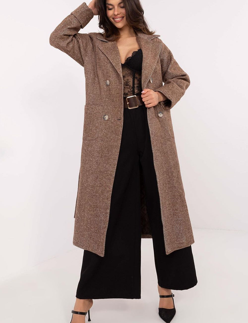 Woman wearing a Selvarane Long Double-Breasted Wool Coat with belted waist and fine stripes, styled elegantly over black attire.