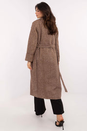 Rear view of woman wearing Selvarane Long Double-Breasted Wool Coat with belted waist and fine stripe pattern, walking indoors.