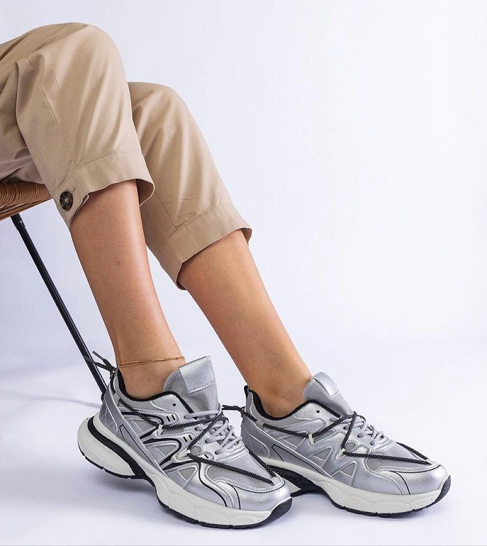 Person wearing Yndessa Sculpted Sole Lace Sneakers with eco leather in a stylish, casual setting.
