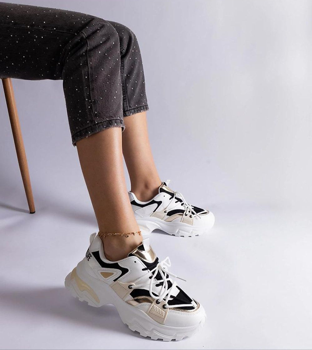 Person wearing Selvyna Contrast Sport Sneakers in black-and-white with eco leather upper and 5 cm supportive sole.