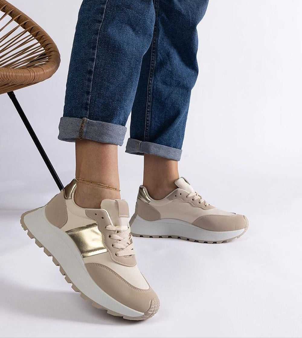 Model wearing Veressa Minimal Platform Sneakers in beige, featuring a modern low-cut design and rubber platform for versatile style.