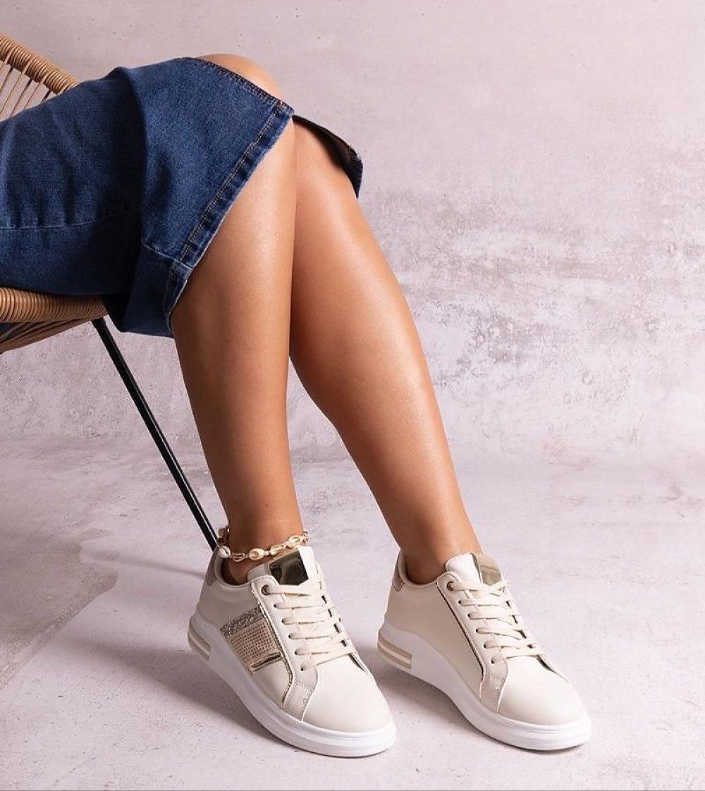 Woman wearing Meralla Rhinestone Platform Sneakers in beige with rhinestone details and a 4 cm sole, styled with a denim dress.