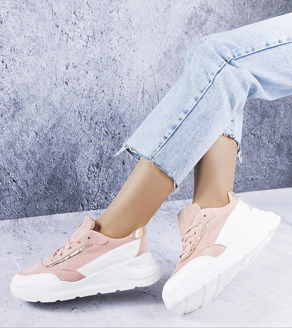 Woman wearing Ismerra Suede Platform Lace Sneakers with eco suede upper and platform sole, styled with light denim jeans.