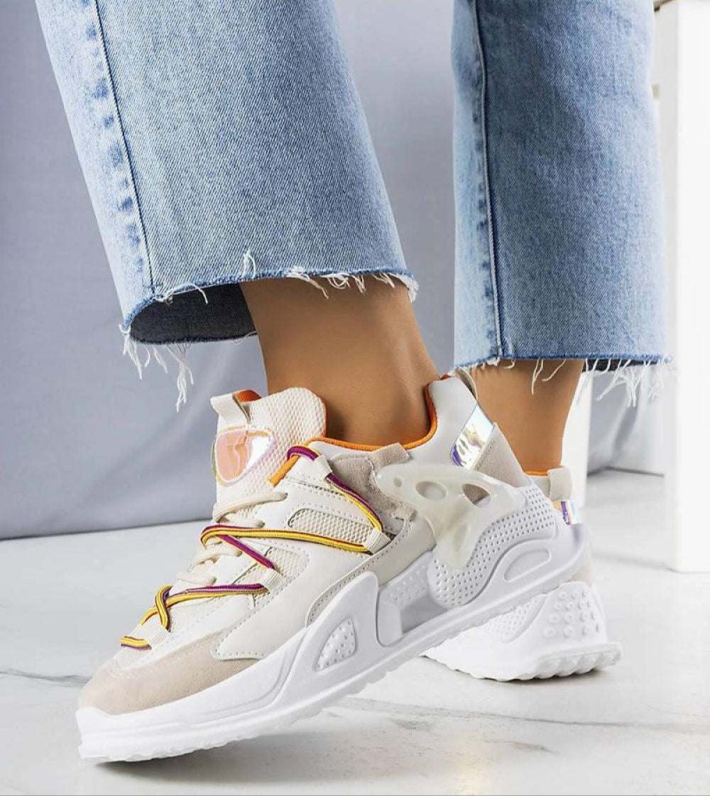 Person wearing Yllendra mixed texture platform sneakers in denim jeans, showcasing eco leather and layered design with 5 cm rubber sole.