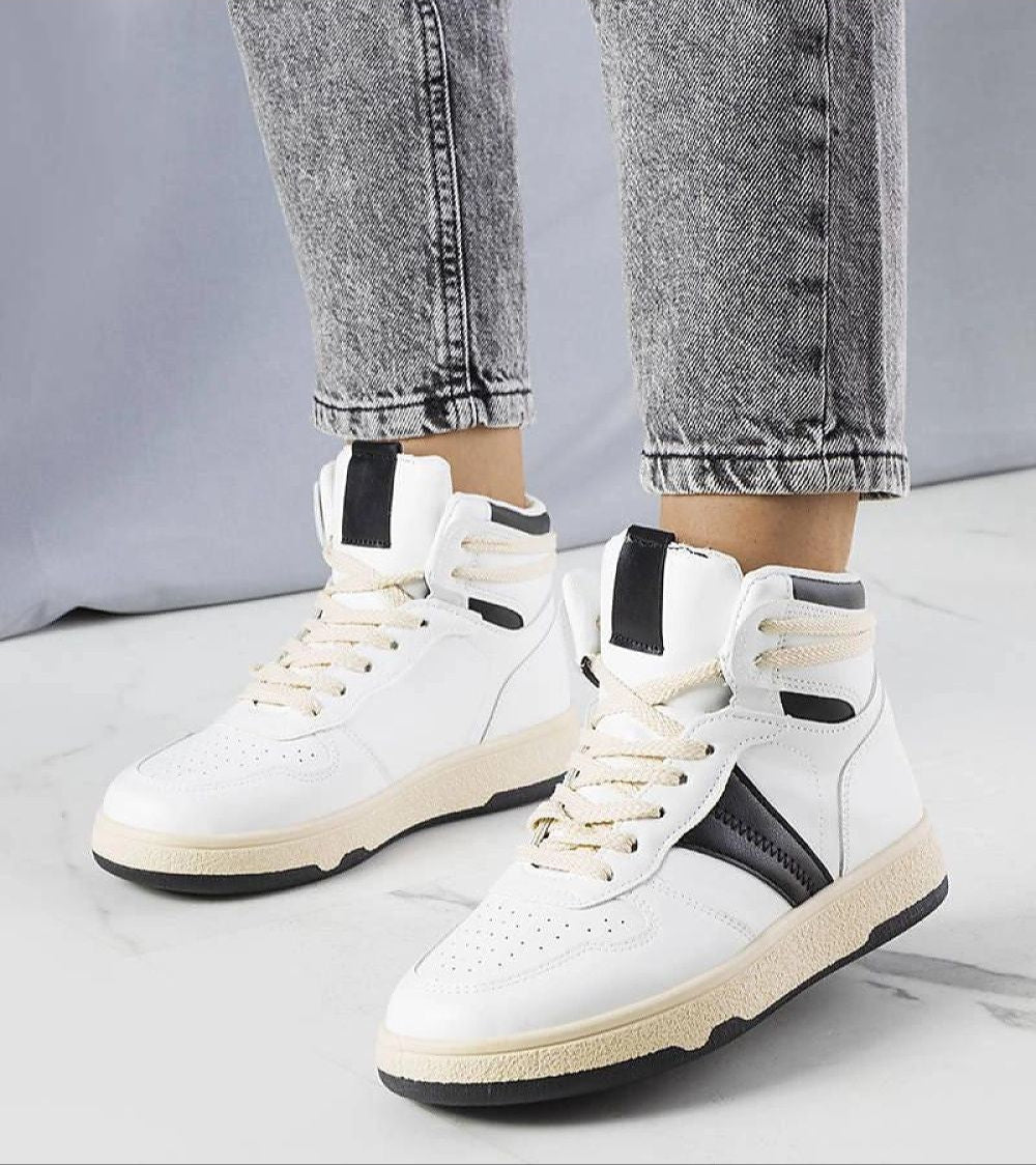 Person wearing Ormelya high-top sneakers with eco leather upper and 3 cm sole, styled in a casual setting with jeans.