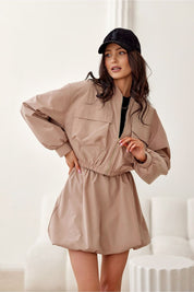 Woman wearing Valserra Lined Bomber Jacket with cap, showcasing casual design and functionality for versatile streetwear style.