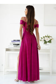 Woman wearing an elegant plus size magenta maxi dress with delicate straps and flowing hem, perfect for formal occasions.