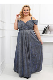 Plus Size Luméra Draped Maxi Dress with shimmering fabric, wrap-style neckline, and sheer sleeves, perfect for evening events.