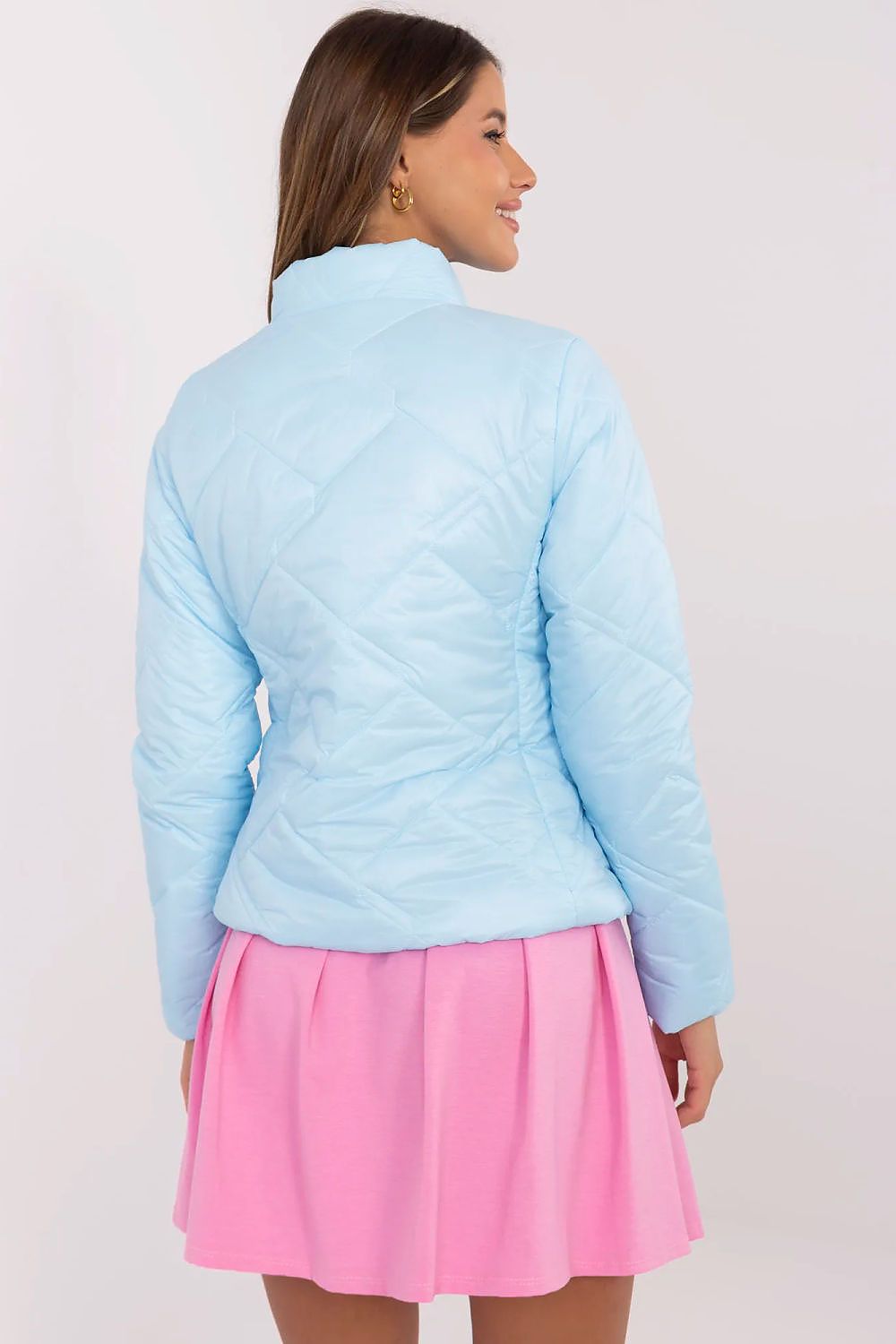 Back view of a woman wearing a light blue Morvianne Quilted Zip-Front Jacket over a pink skirt.