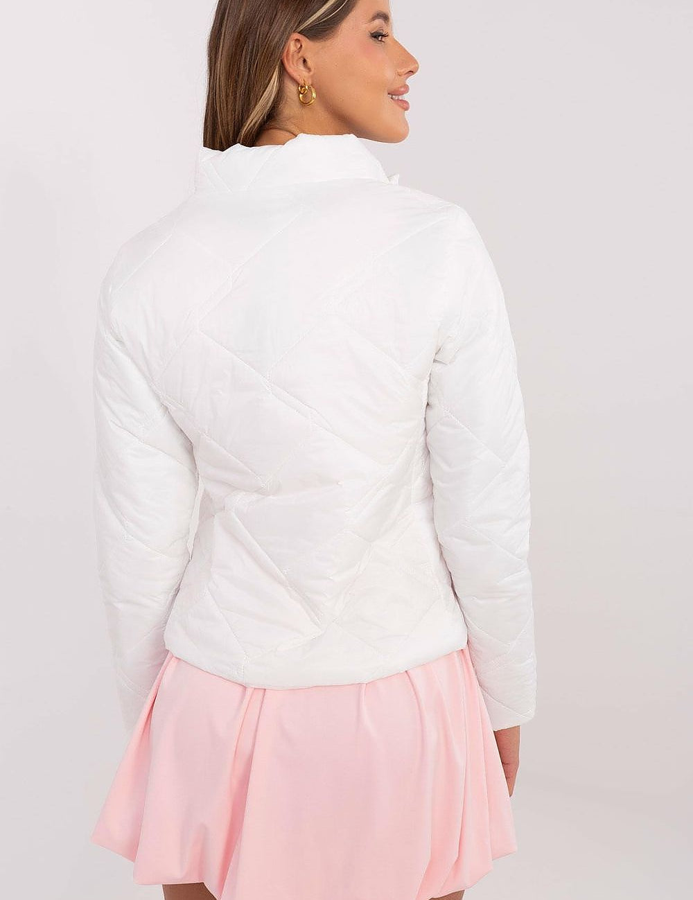 Rear view of woman wearing Morvianne Quilted Zip-Front Jacket, showcasing quilted nylon design with long sleeves and pink skirt.