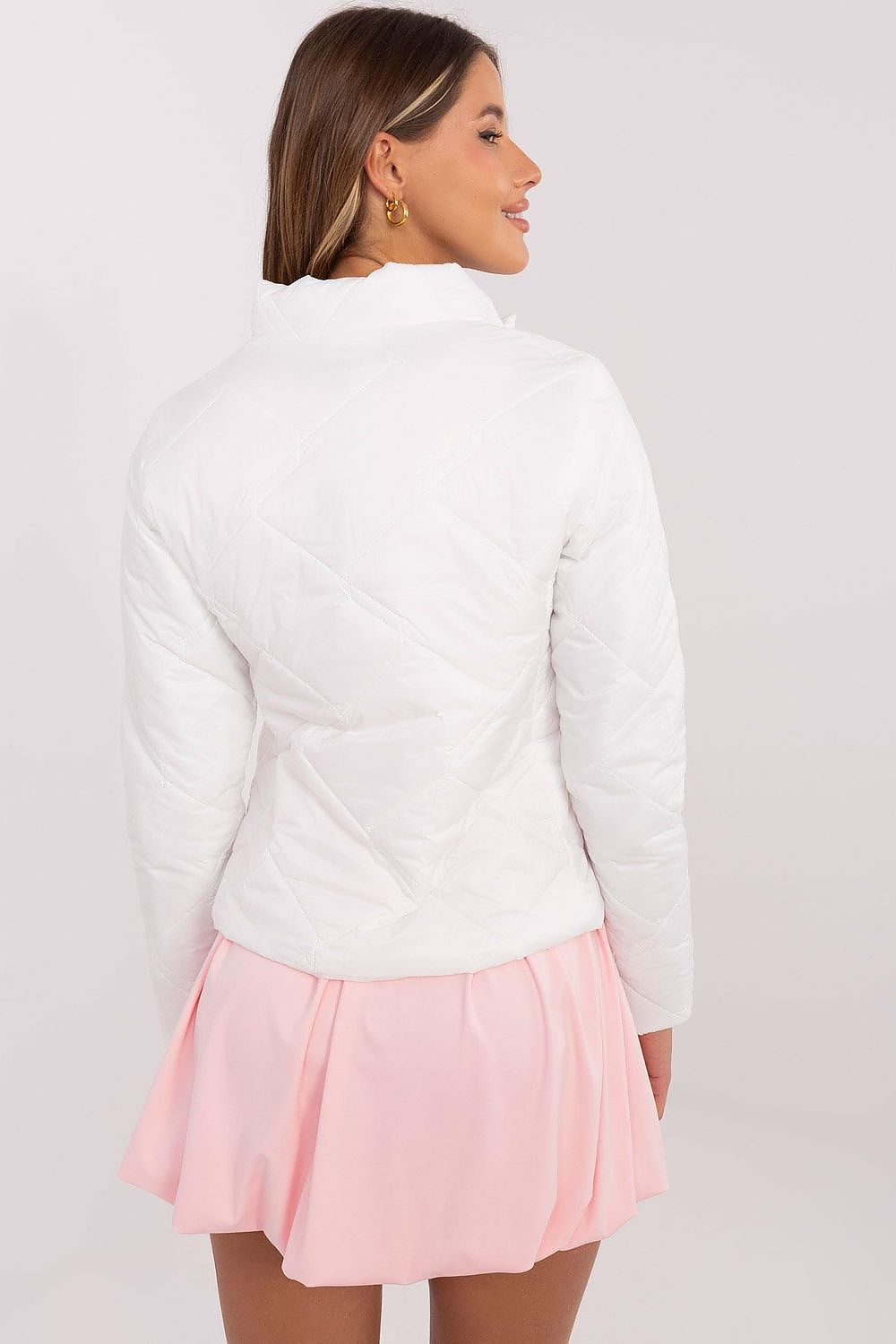 Rear view of woman wearing Morvianne Quilted Zip-Front Jacket, showcasing quilted nylon design with long sleeves and pink skirt.