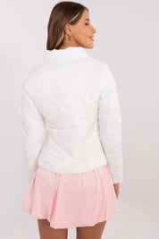 Rear view of woman wearing Morvianne Quilted Zip-Front Jacket, showcasing quilted nylon design with long sleeves and pink skirt.