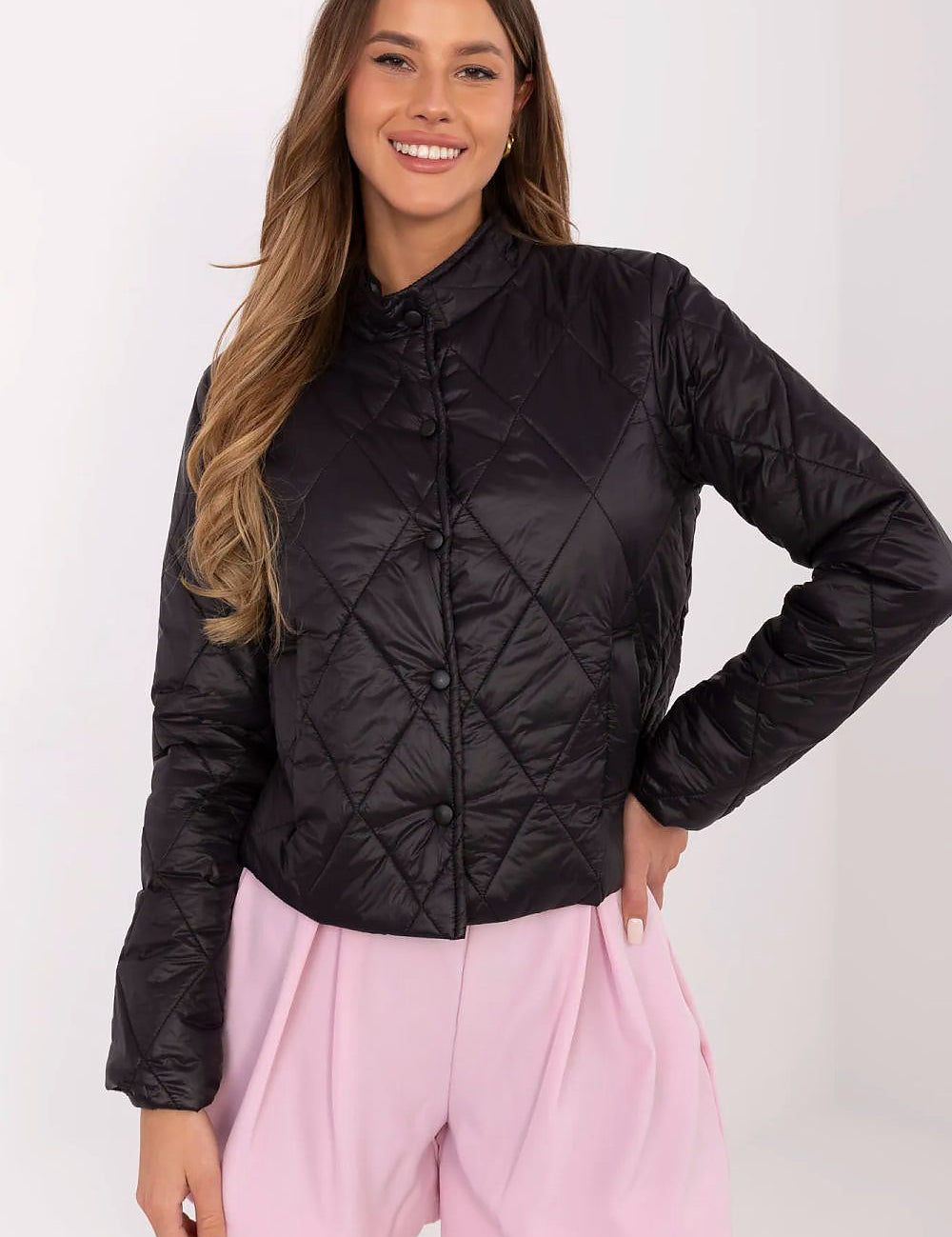 Woman wearing Alverise Quilted Snap-Front Jacket in black, lightweight nylon, wind-resistant, casual style, with slip pockets.