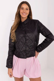 Woman wearing Alverise Quilted Snap-Front Jacket in black, lightweight nylon, wind-resistant, casual style, with slip pockets.