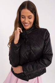 Woman wearing Alverise Quilted Snap-Front Jacket in black, showcasing a wind-resistant, hoodless design with a modern, casual style.