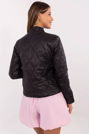 Woman wearing black Alverise Quilted Snap-Front Jacket, showing back view. Lightweight nylon, modern and casual style jacket.