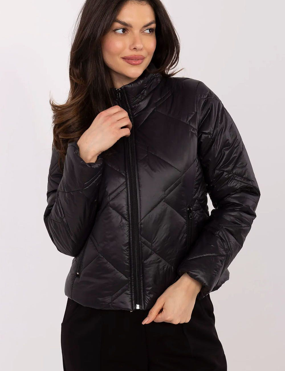 Woman wearing Morvianne Quilted Zip-Front Jacket in black, showcasing its sleek design and practical front zip closure.