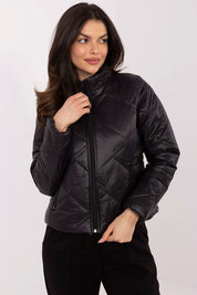 Woman wearing Morvianne Quilted Zip-Front Jacket in black, showcasing its sleek design and practical front zip closure.