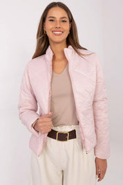 Woman wearing Morvianne Quilted Zip-Front Jacket in pink, showcasing its sleek, wind-resistant design and front zipper closure.