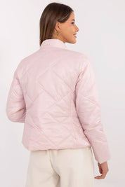 Back view of woman wearing Morvianne Quilted Zip-Front Jacket in pink, showcasing quilted nylon design and zippered pockets.