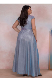 Back view of a plus-size woman wearing a shimmering blue evening dress with cap sleeves, showcasing elegance and style.