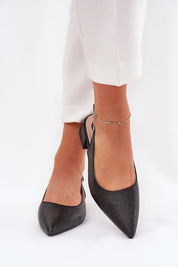Woman wearing Merdalia pointed-toe woven sandals with ankle strap, styled with white trousers, showcasing elegant summer footwear.