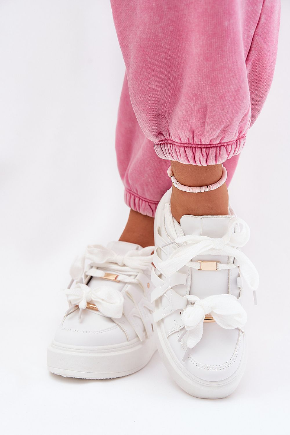Cernia Synthetic Platform Lace Sneakers in white with thick sole, worn with pink joggers, showcasing streetwear style and comfort.