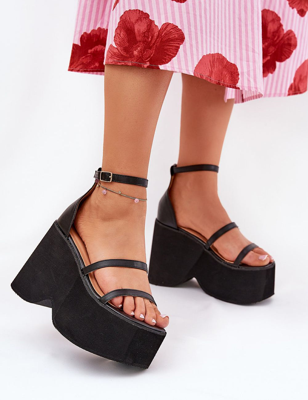 Arlona Echo Wedge Sandals with eco leather straps and adjustable ankle strap, worn with a floral skirt for a chic summer look.