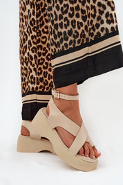 Lirianne Platform Buckle Sandals in eco leather with wedge platform and ankle strap, styled with leopard print pants for a chic look.