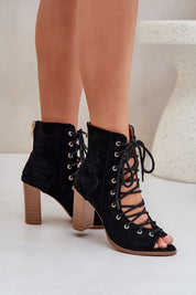 Rinella Block Heel Lace Sandals in black eco suede with block heel, featuring intricate laced design and back zipper for easy wear.