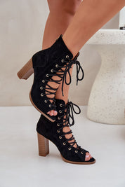 Rinella Block Heel Lace Sandals in black eco suede with bold block heel and intricate lacing, perfect for summer or elegant occasions.