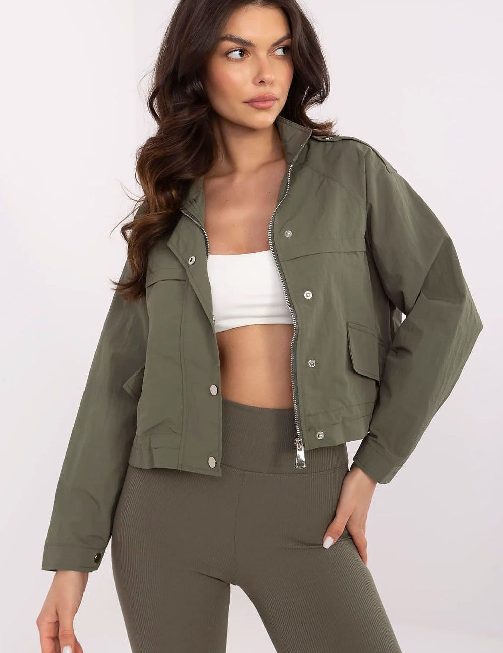 Woman wearing Corvaline lightweight windbreaker jacket with full-length zipper, suitable for spring and summer, styled with leggings.