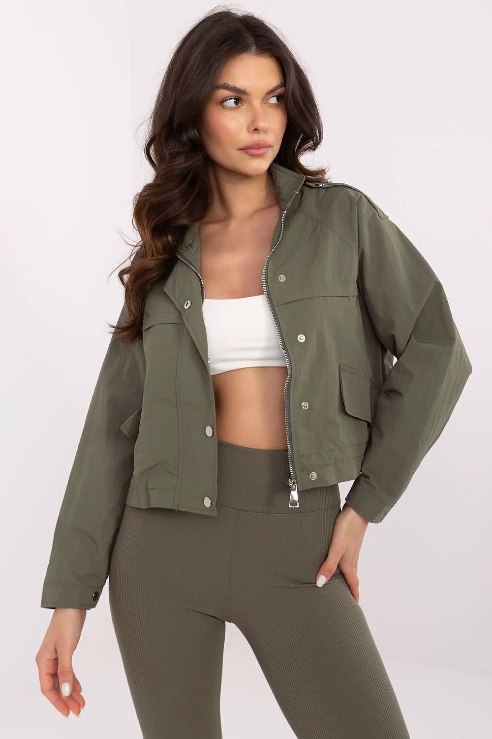 Woman wearing Corvaline lightweight windbreaker jacket with full-length zipper, suitable for spring and summer, styled with leggings.