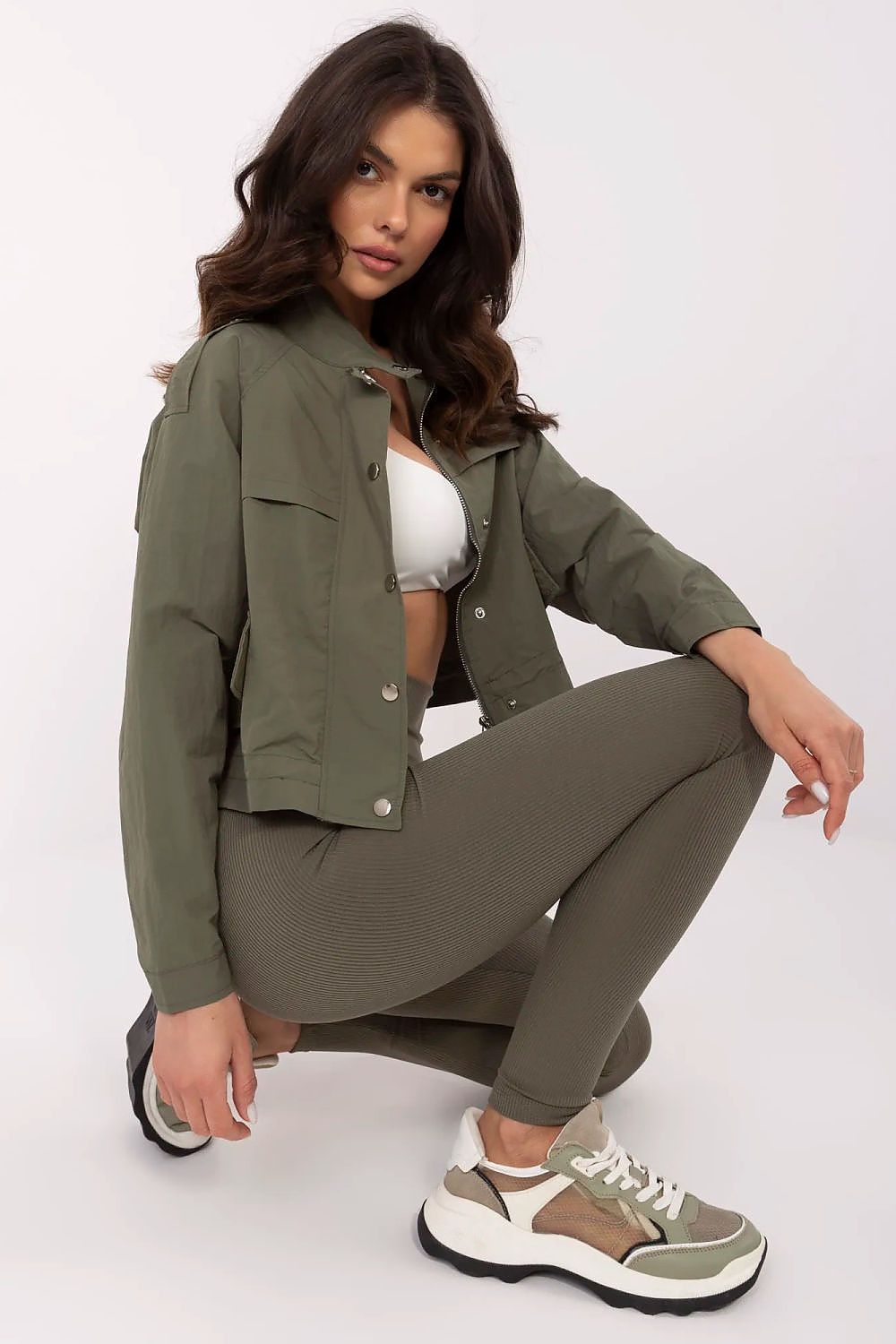 Model wearing Corvaline Lightweight Windbreaker Jacket with sporty outfit, showcasing its versatile style and full-length zipper.