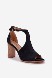 Elegant black Elanvera suede heeled sandal with buckle strap, made of soft eco-suede, featuring a 9 cm stable heel for comfort.