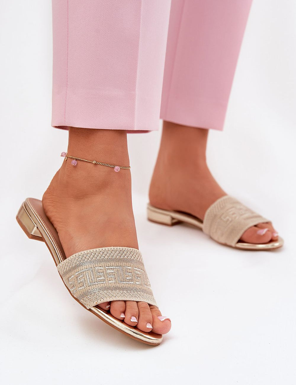 Arelia Flat Summer Slides featuring breathable textile upper and eco-leather insole, perfectly paired with pink pants for warm days.