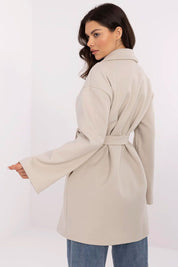Woman wearing Selvarinne Double-Breasted Short Coat with waist tie, shown from back, in neutral setting; ideal for transitional wear.