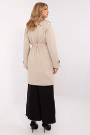 Back view of woman wearing Corvanne Double-Breasted Belted Coat in beige, showcasing knee-length design and modern style.