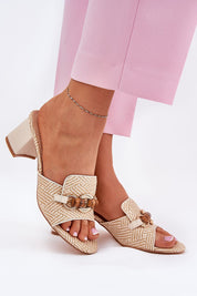 Mireta woven slip-heel sandals with intricate pattern, sculptural design, and pillar heel, perfect for summer fashion and casual outings.