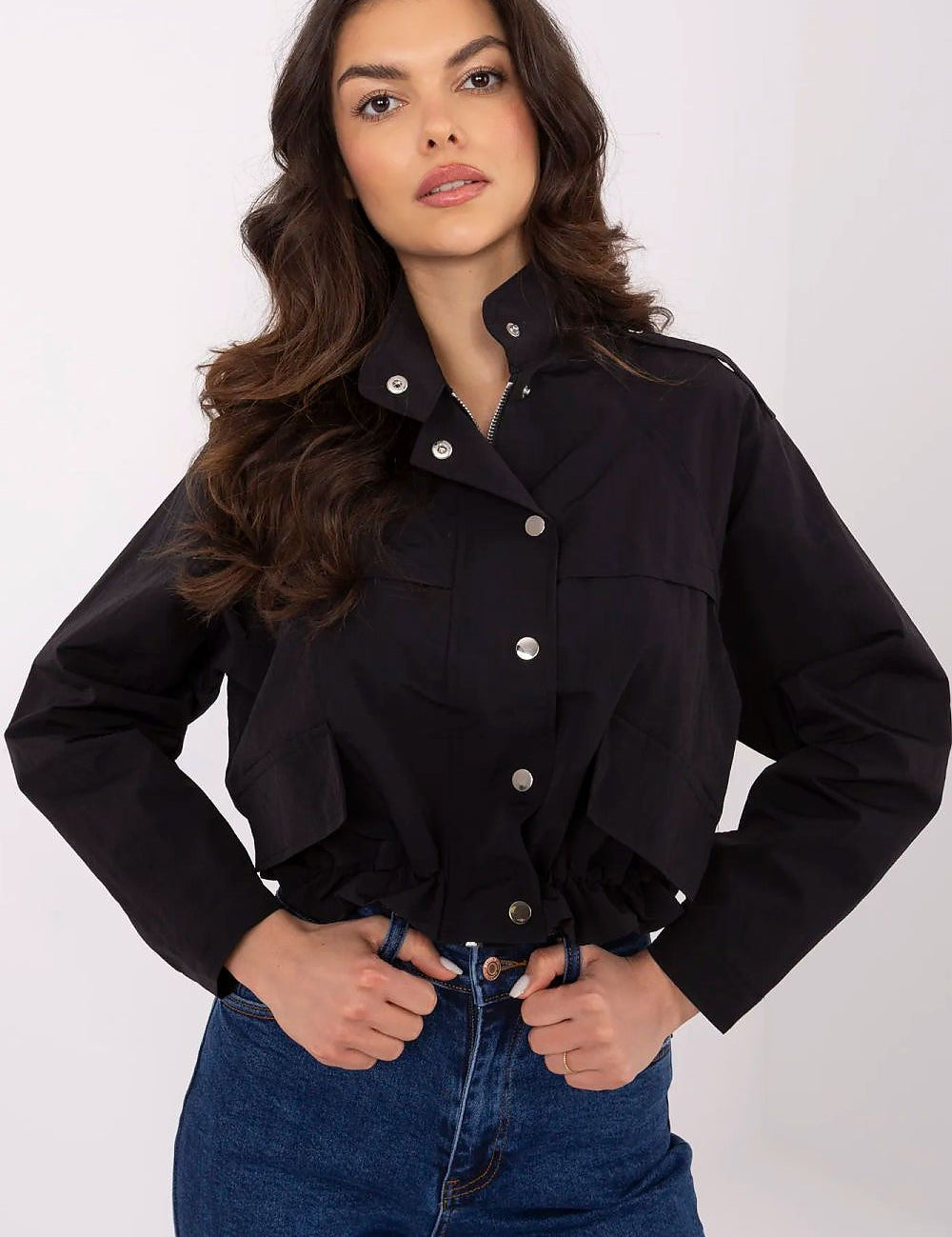 Woman wearing Corvaline Lightweight Windbreaker Jacket in black with snap-button placket and epaulets, paired with jeans.