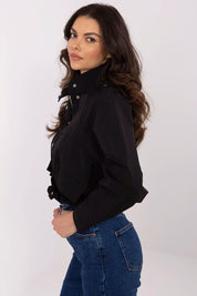 Model wearing Corvaline Lightweight Windbreaker Jacket in black with concealed zipper and snap-button placket, paired with jeans.