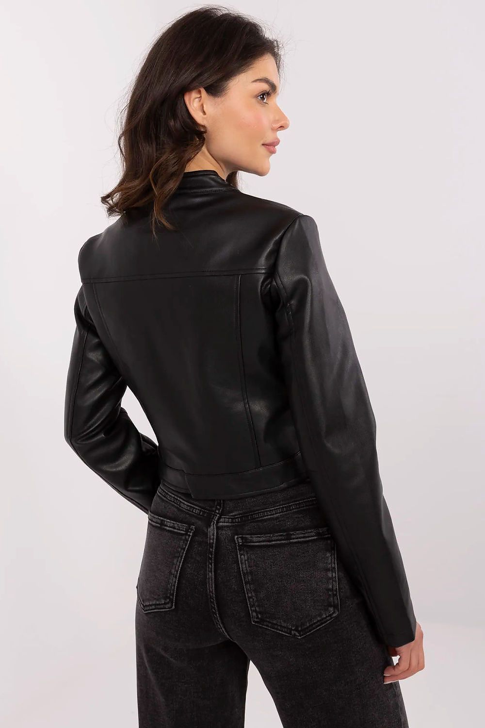 Woman wearing Corvanelle Eco-Leather Zip Jacket in black, showcasing fitted cut and long sleeves for versatile styling.