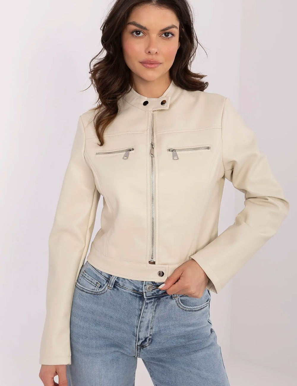 Woman wearing Corvanelle Eco-Leather Zip Jacket with fitted cut, featuring a full-length zip, minimalist design, paired with jeans.