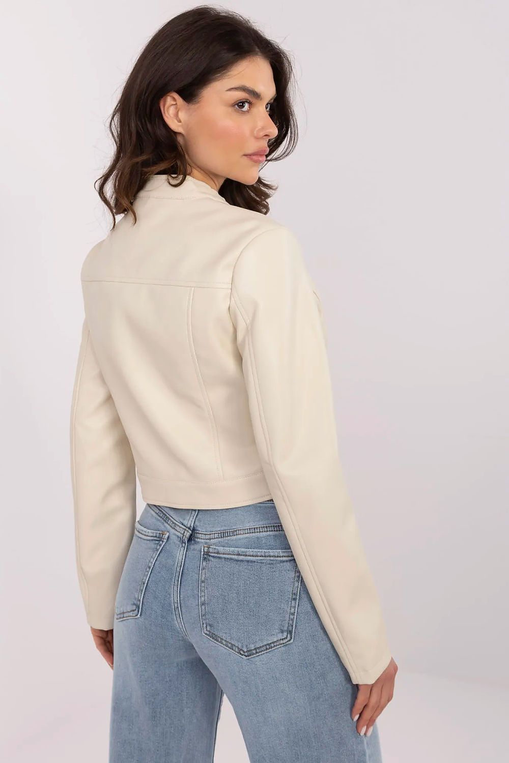 Woman wearing Corvanelle eco-leather zip jacket in a short, fitted style, showcasing minimalist design and versatile styling options.