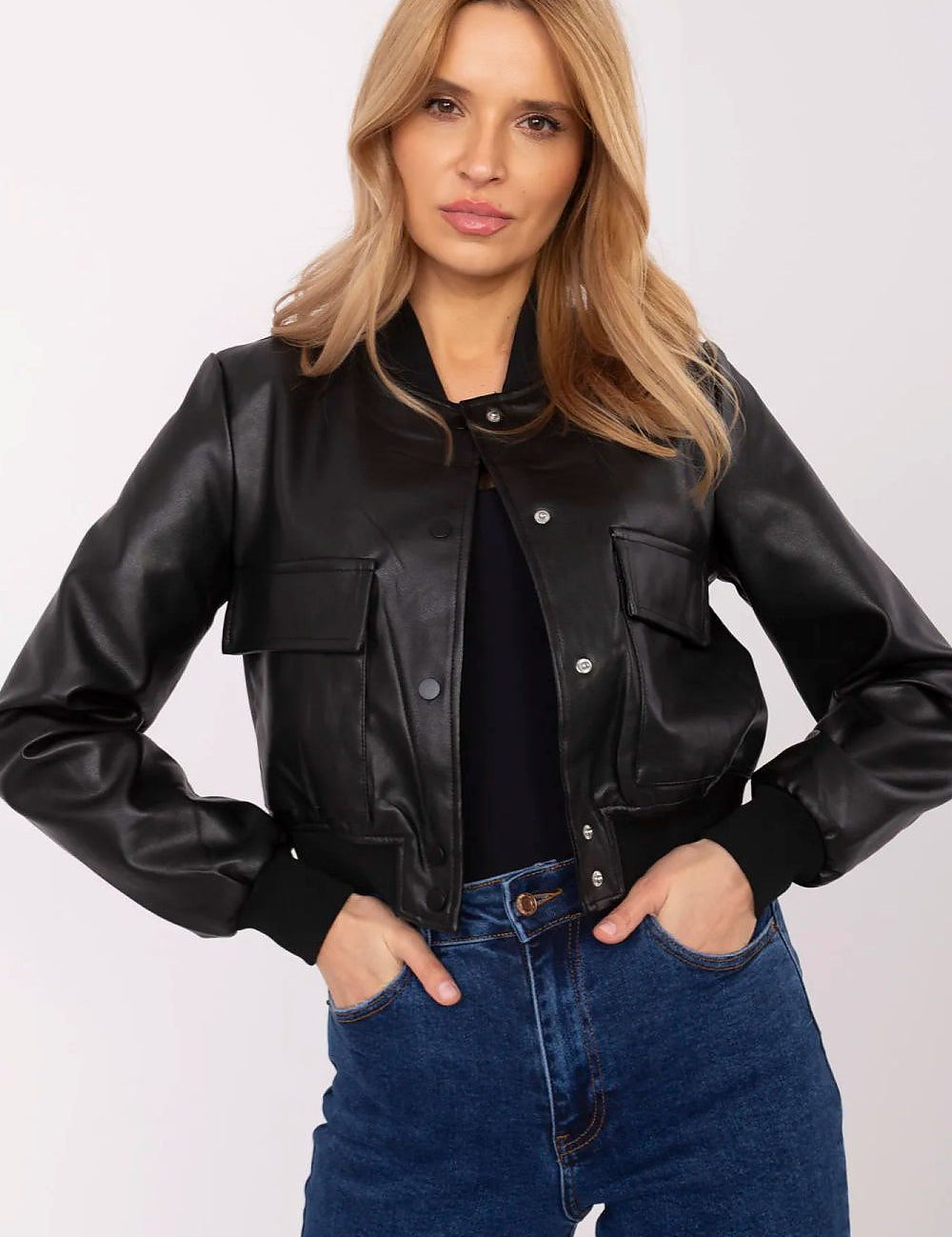 Woman wearing Velvaris Eco-Leather Bomber Jacket with snap-button closure and front flap pockets, styled for transitional seasons.
