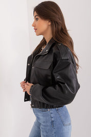 Woman wearing Arvenique eco-leather short jacket with flap pockets and shoulder epaulettes, side profile view.