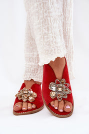 Red Fiorenna suede flower sandals with decorative accents and cushioned insoles, featuring an adjustable ankle strap for comfort.